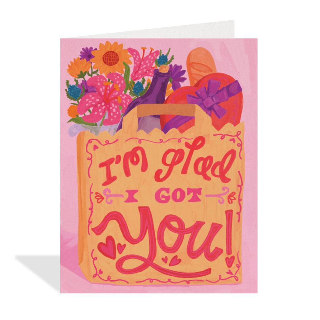 Greeting card design by Erin Mac. A charming illustration of a paper bag with flowers and groceries inside with a sentiment on the bag that reads "I'm glad I got you".