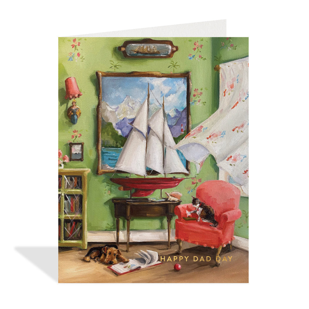 Greeting card design by Canadian Artist, Lisa Finch. A lovely illustration of a room scene with a dog laying beside a book and a cat playing on a red chair. The wind blowing the curtains and a sail boat sitting perfectly on a side table with a gold foil sentiment that reads "happy dad day".