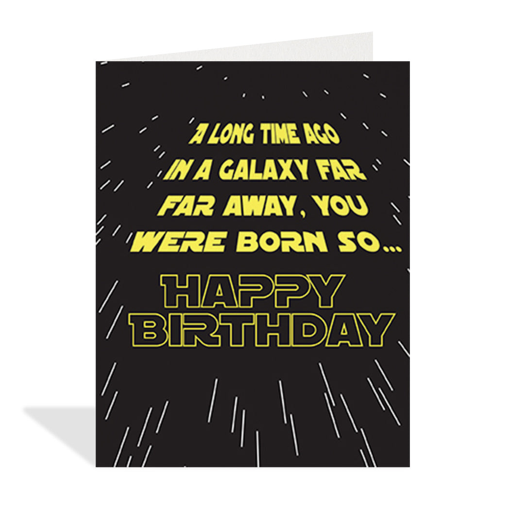 Greeting card designed by Halfpenny Postage. The birthday card features a Star Wars style typography design, with yellow lettering and a black background. The text reads "a long time ago in a galaxy far, far away, you were born so… happy birthday".