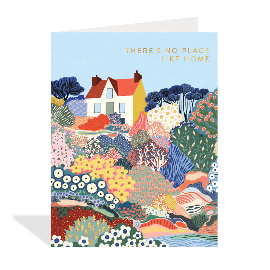 Greeting card designed by Marina Castaldo. A beautiful illustration of a house sitting in a meadow full of flowers. A gold foil sentiment that reads, "there's no place like home".