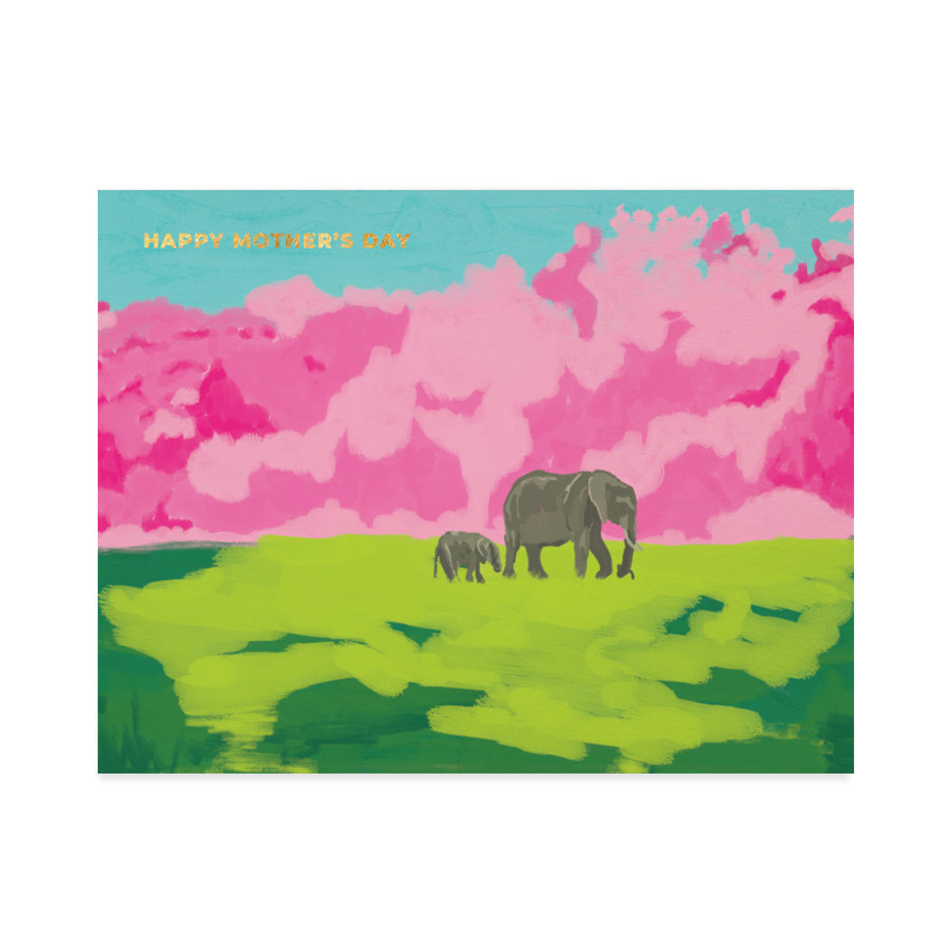 Greeting card design by Canadian Artist, Shira Sela. A cute illustration of a mother elephant and her calf strolling on a big grassy field with a gold foil sentiment that reads "happy mother's day".
