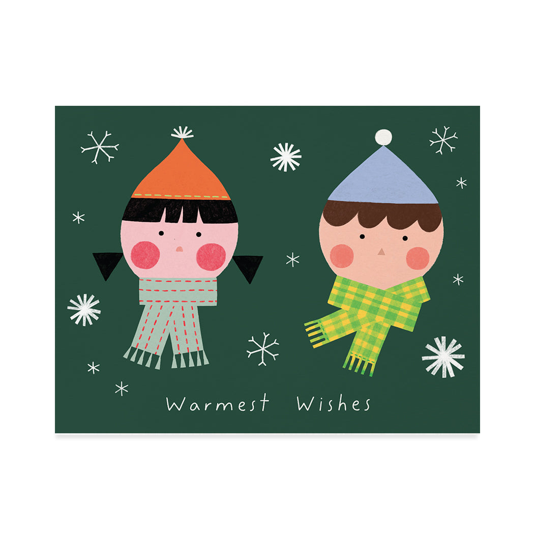 Greeting card illustration by Joy Kim. Cute illustration of two elves wearing scarves and hats on a dark green background with snow flakes around them. Typography that reads "warmest wishes"